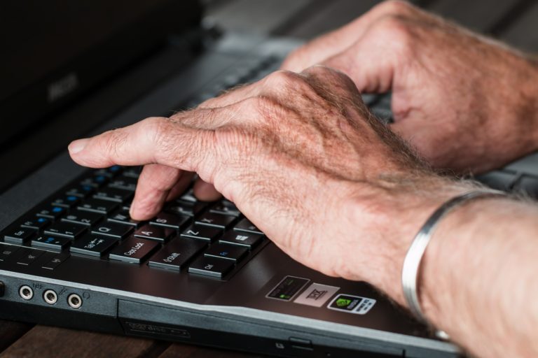 Pair of hands typing on keyboard