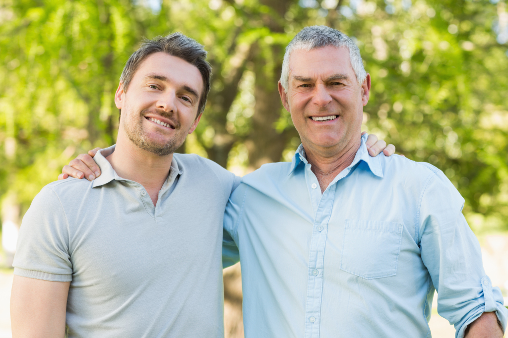 Portrait Of A Smiling Father With Adult Son At The Park Caring Considerations