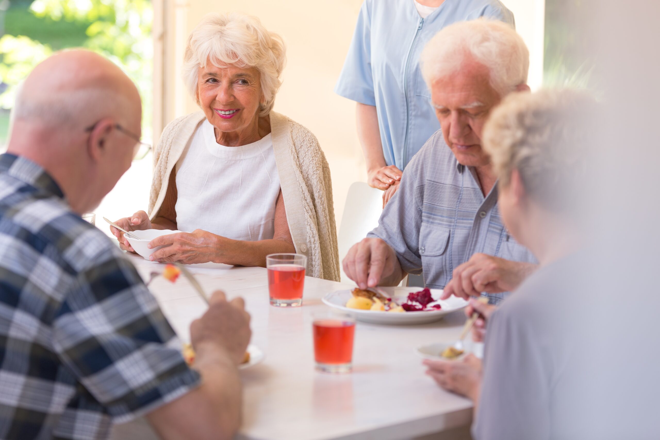 Group of pensioners eating lunch together