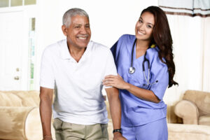 A nurse assisting an elderly man in a living room.