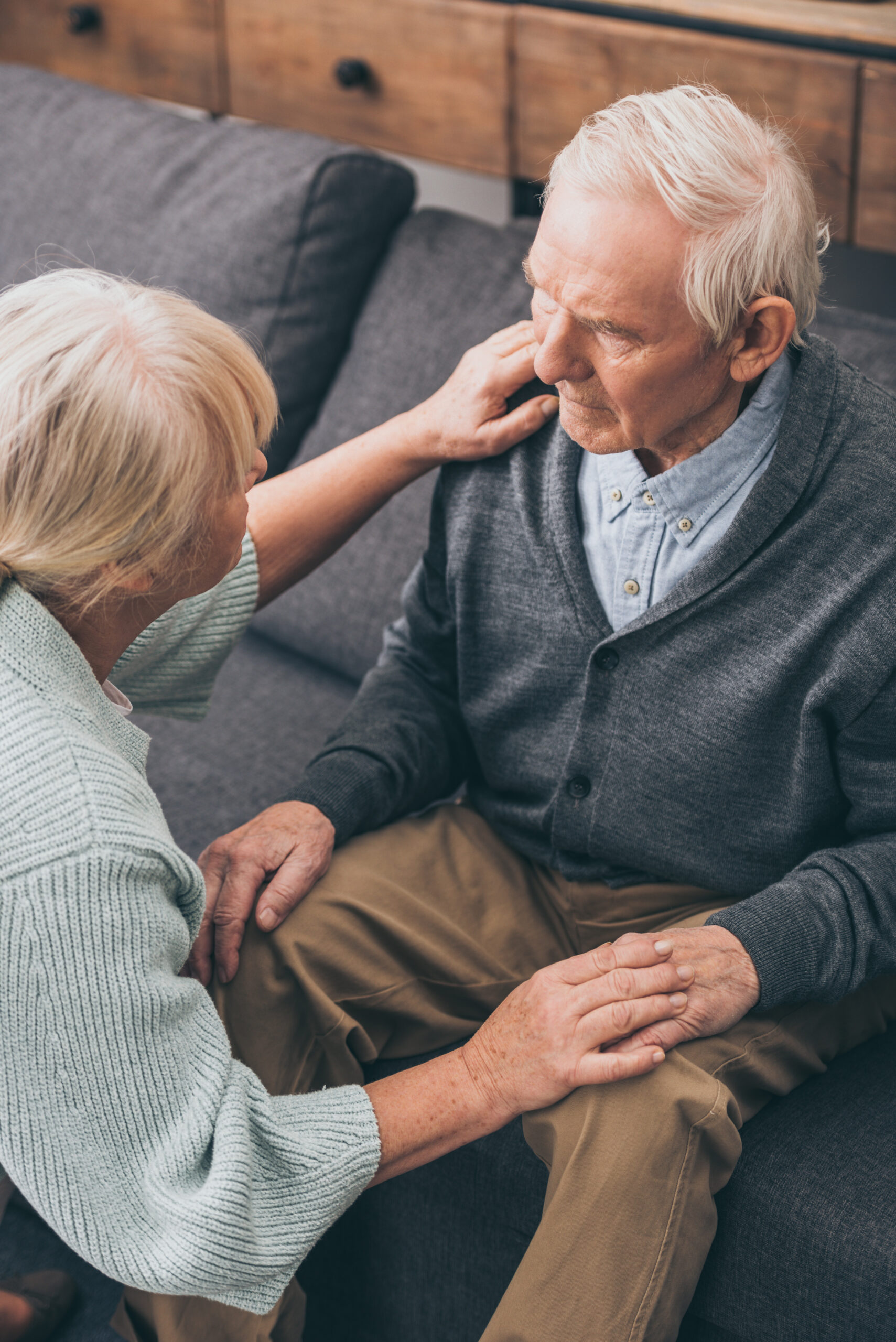 senior couple holding hands and looking at each other at home – Caring ...